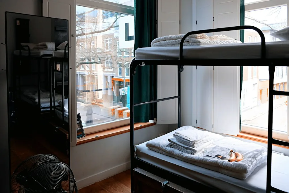 Bright shared hostel room with bunk beds